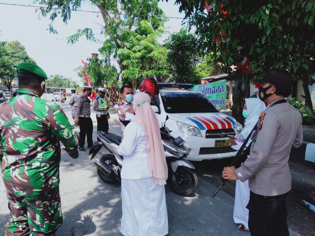 Polres Tanjung Balai Lakukan Penyekatan Warga yang Hendak Mudik dan Bagikan Masker kepada Pengendara