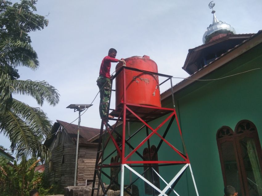 Di Bawah Terik Matahari, Satgas TMMD ke-127 Kodim 0212/TS Sertu Himsar Panjaitan Cat Toren Sumur Bor Demi Air Bersih Warga Sangkunur